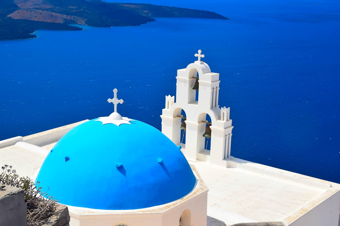 Blue-domed church overlooking the Aegean Sea on a Greek island