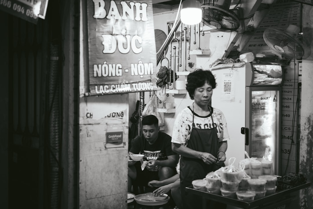 Close-up of a bowl of pho being served at a Hanoi street stall