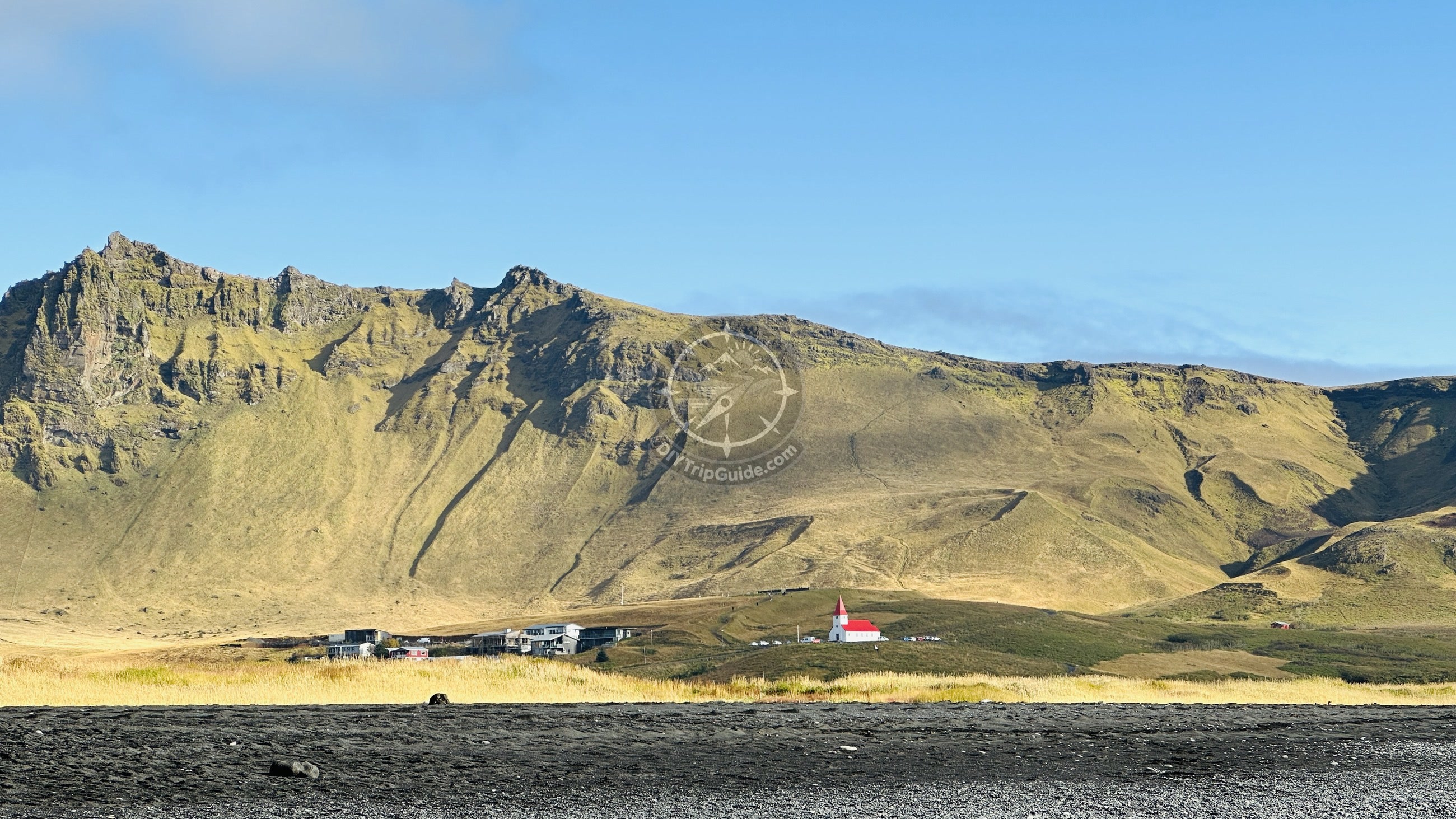 The black-sand coast near Reynisfjara, photographed from a safe inland viewpoint.