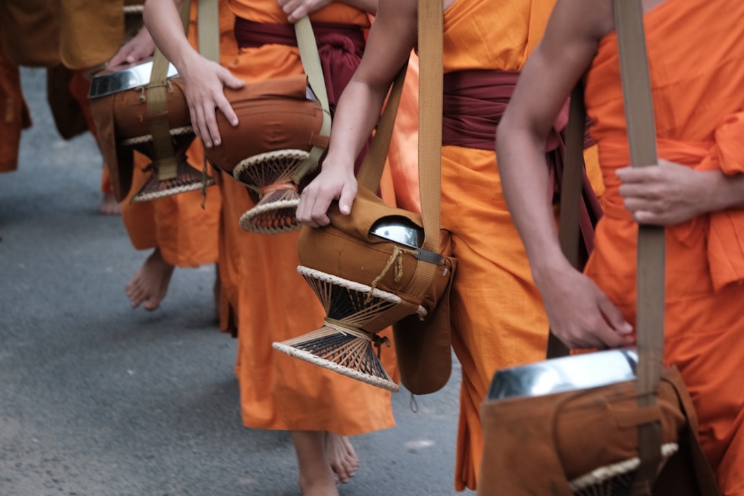 Buddhist monks walking in a line during morning alms ceremony in Luang Prabang