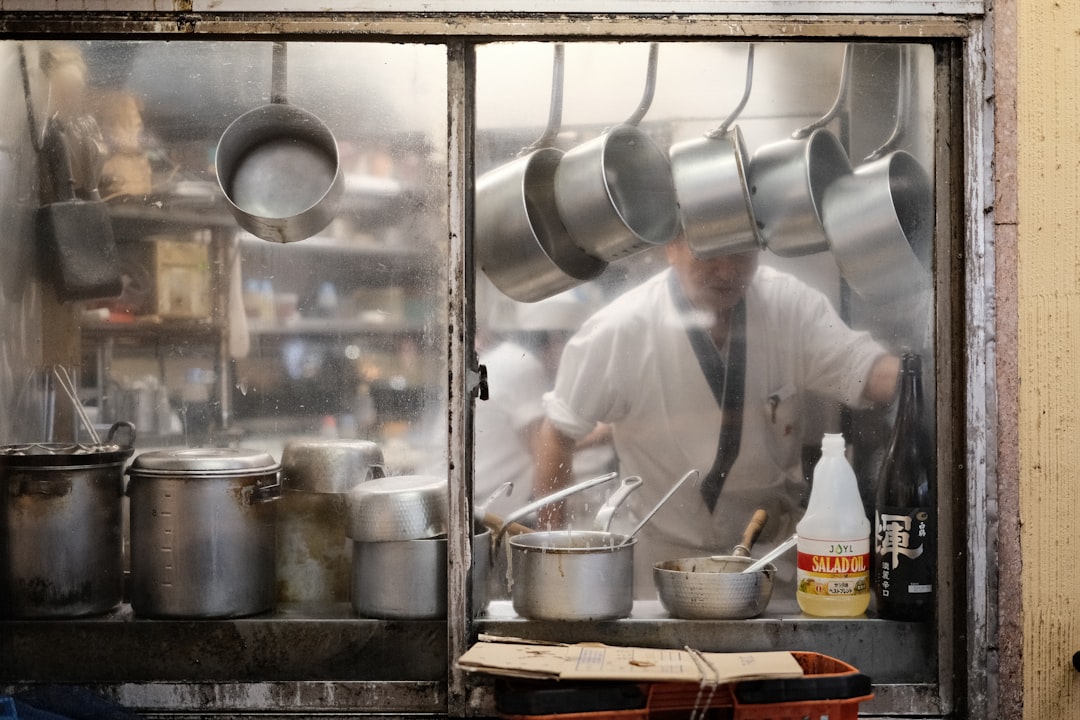 Busy Tokyo street food alley with lanterns and steam rising from stalls